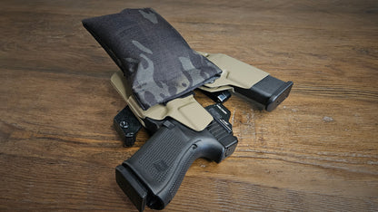 Black MultiCam Stallster holster pillow attached to the back of a Tier 1 Concealed sidecar holster, carrying a Glock 19 and extra mag