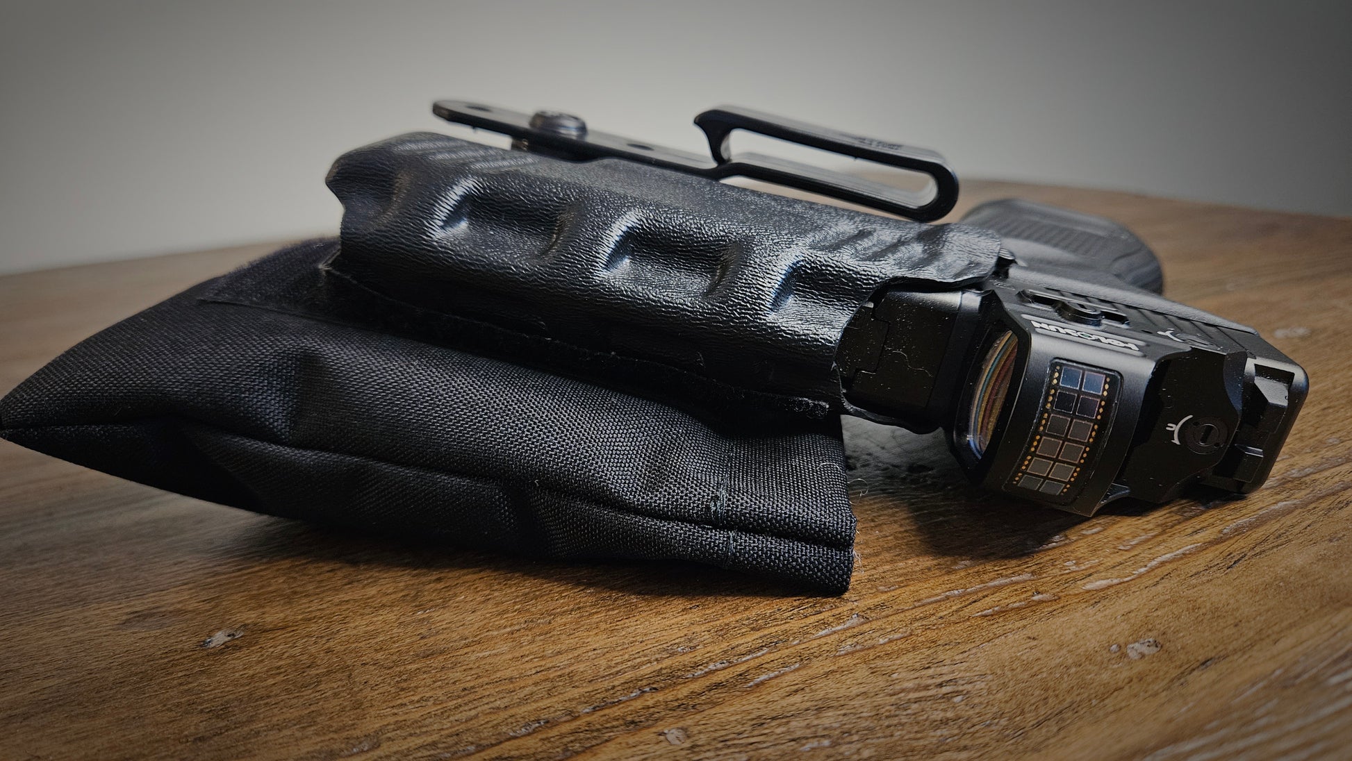Black Stallster holster pillow attached to AIWB DeSantis holster carrying a Glock 19
