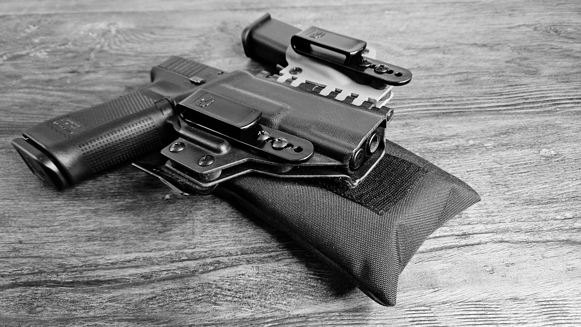 Black Stallster holster pillow attached to the back of a T.Rex Arms sidecar holster, carrying a Glock 17 and extra mag