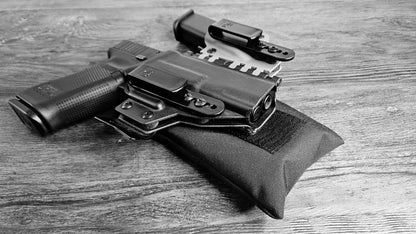 Black Stallster holster pillow attached to the back of a T.Rex Arms sidecar holster, carrying a Glock 17 and extra mag