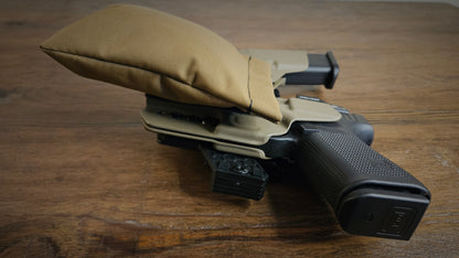 Coyote Stallster holster pillow attached to the back of a Tier 1 Concealed holster, carrying a Glock 19 and extra mag