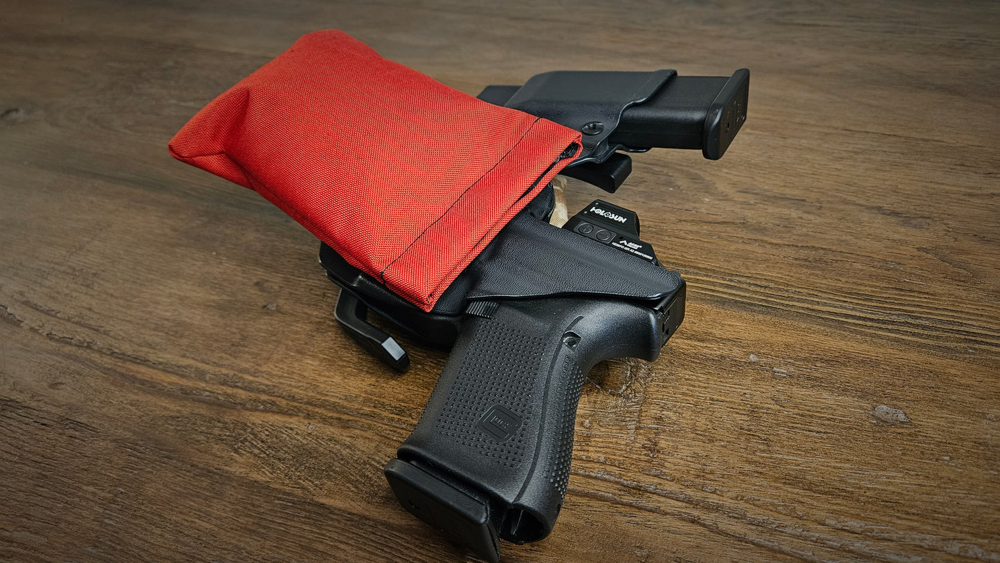 High-vis red Stallster holster pillow attached to the back of a Vedder sidecar holster, carrying a Glock 19 with extra mag