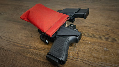 High-vis red Stallster holster pillow attached to the back of a Vedder sidecar holster, carrying a Glock 19 with extra mag