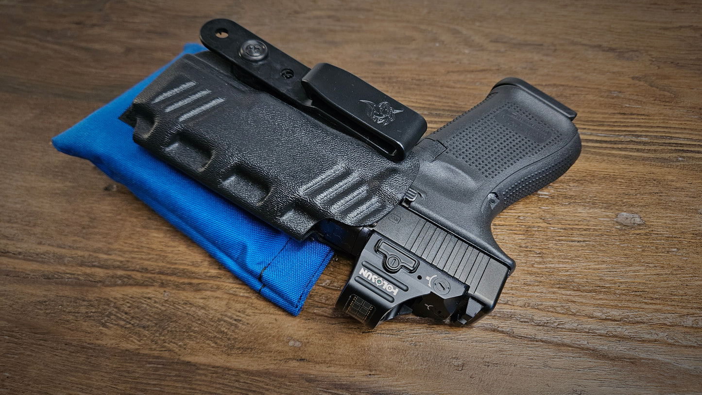 Royal blue Stallster holster pillow attached to the back of a DeSantis holster, carrying a Glock 19