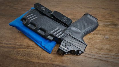 Royal blue Stallster holster pillow attached to the back of a DeSantis holster, carrying a Glock 19